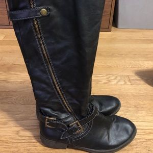 Black, tall boots with brass accents